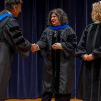 Faculty shaking hands with Robert Smart, and the Provost